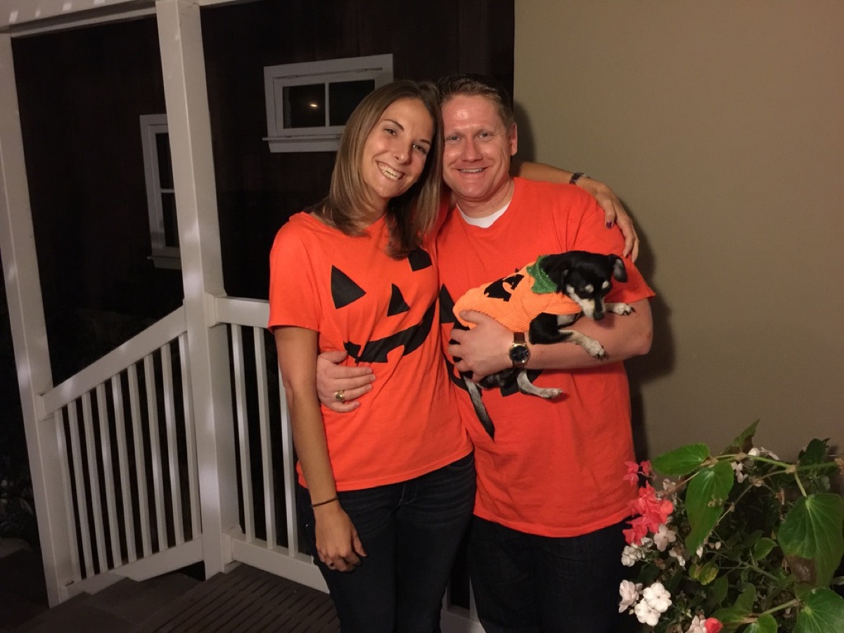 Kyle, Kate, and Drifter in matching pumpkin Halloween shirts