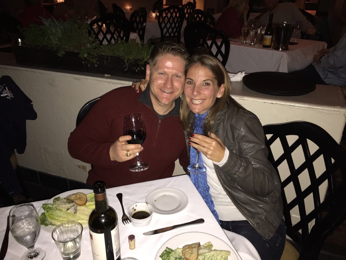 Kyle and Kate toasting with wine after the engagement