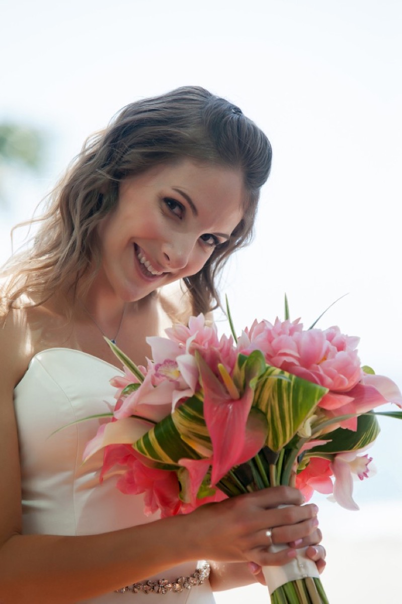 Kate smiling with her pink wedding bouquet