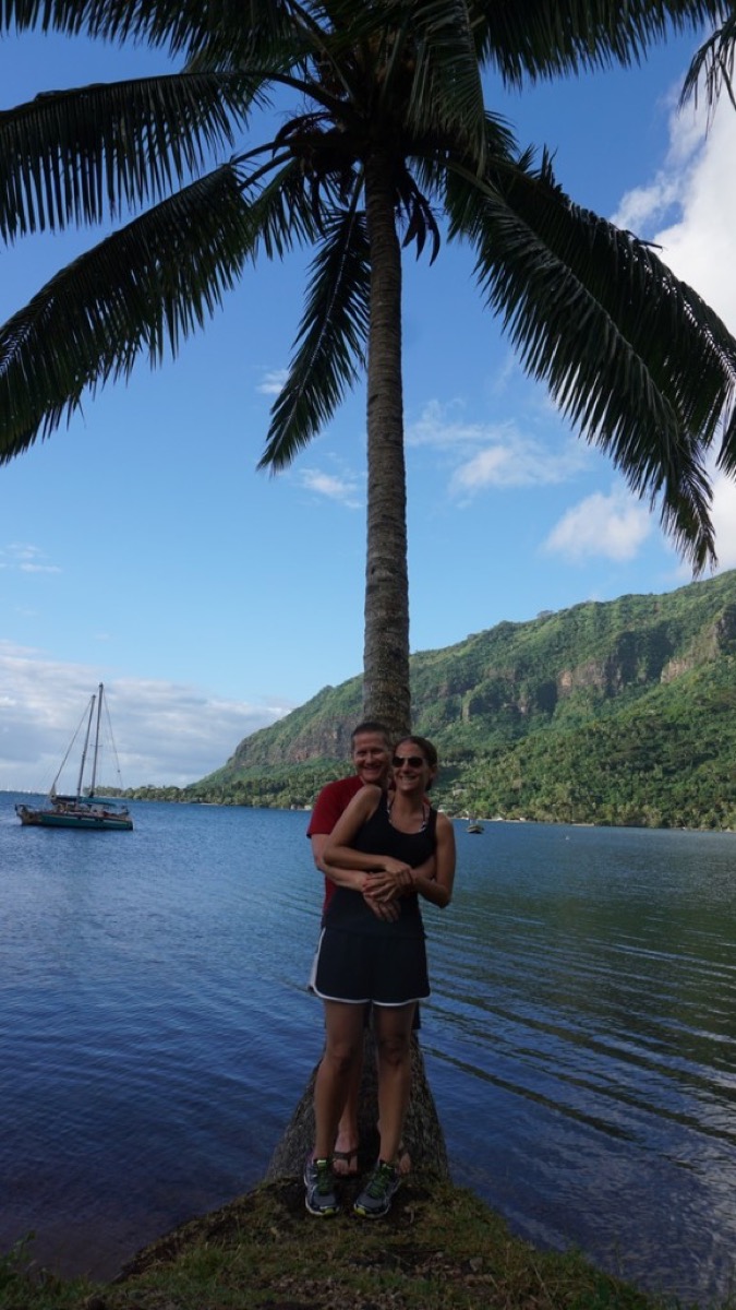 Kyle and Kate by a palm tree on Cook's Bay