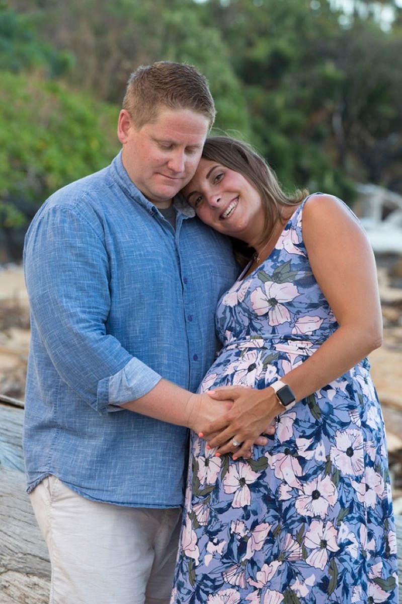 Kyle and Kate with hands on her pregnant belly