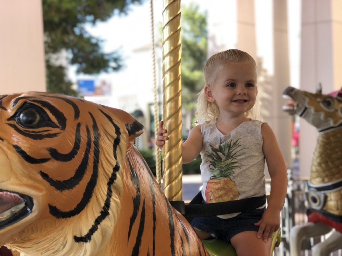Makena on a carousel tiger
