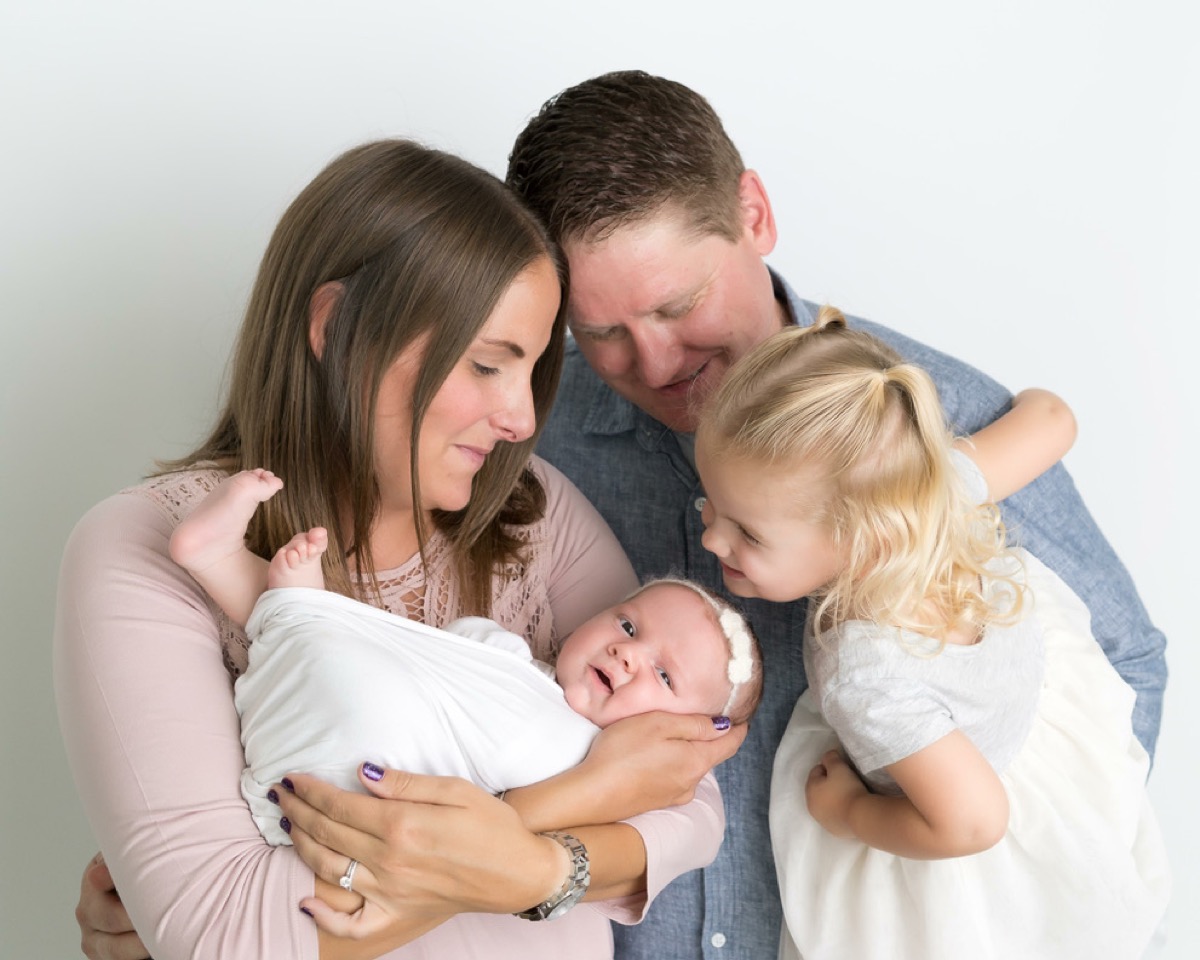 Kyle, Kate, Makena, and newborn Morgan in a studio family portrait