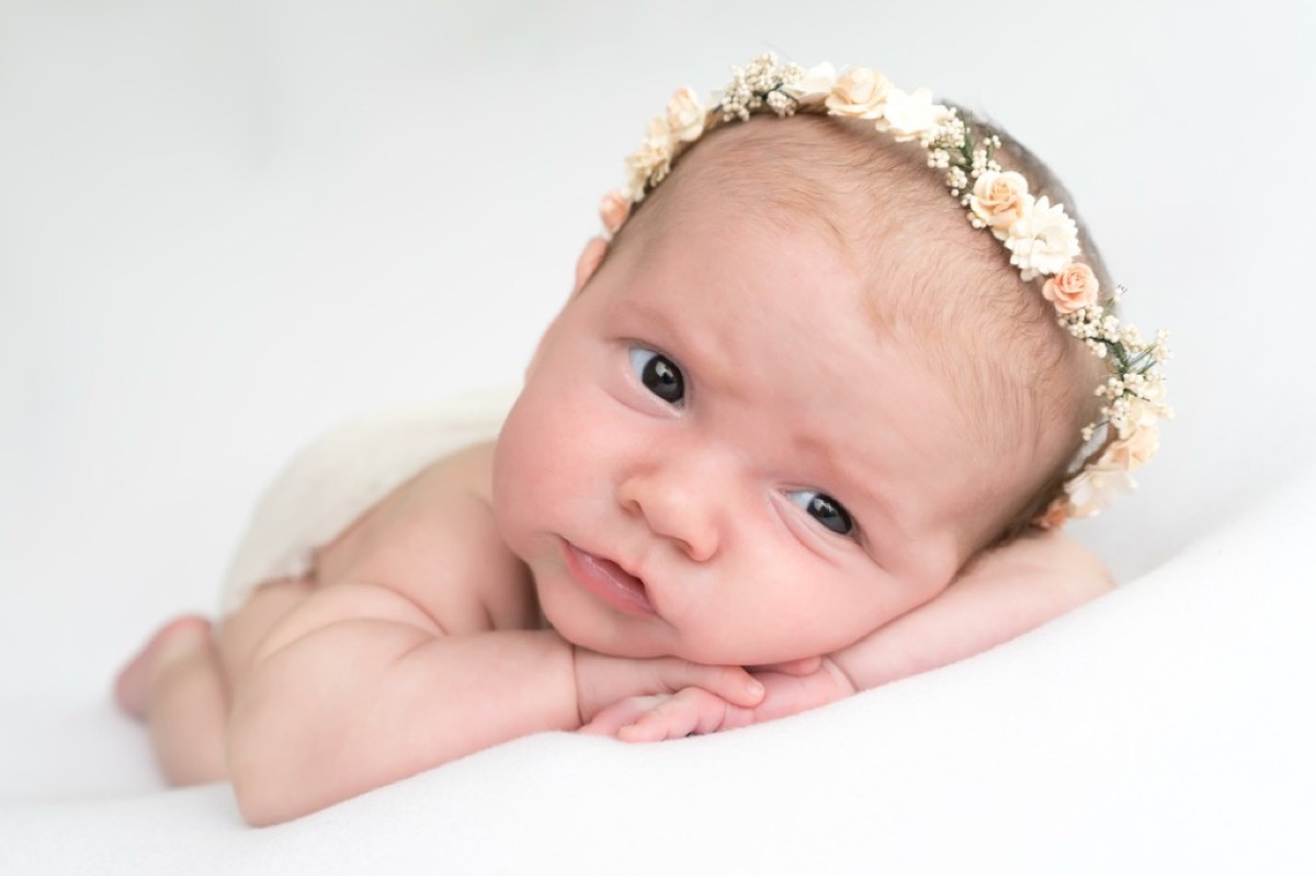Newborn Morgan in a floral crown studio portrait