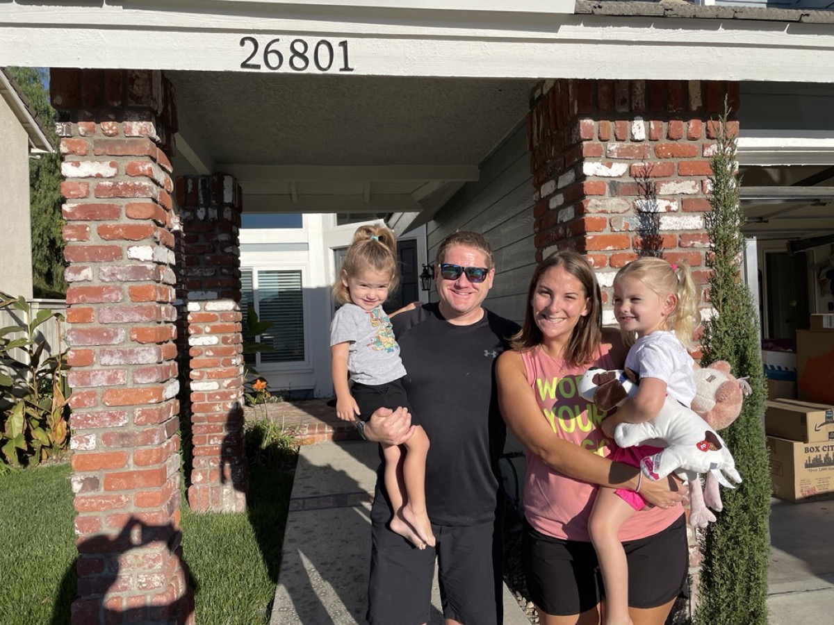 The family on the Bridgeton porch with moving boxes in the garage