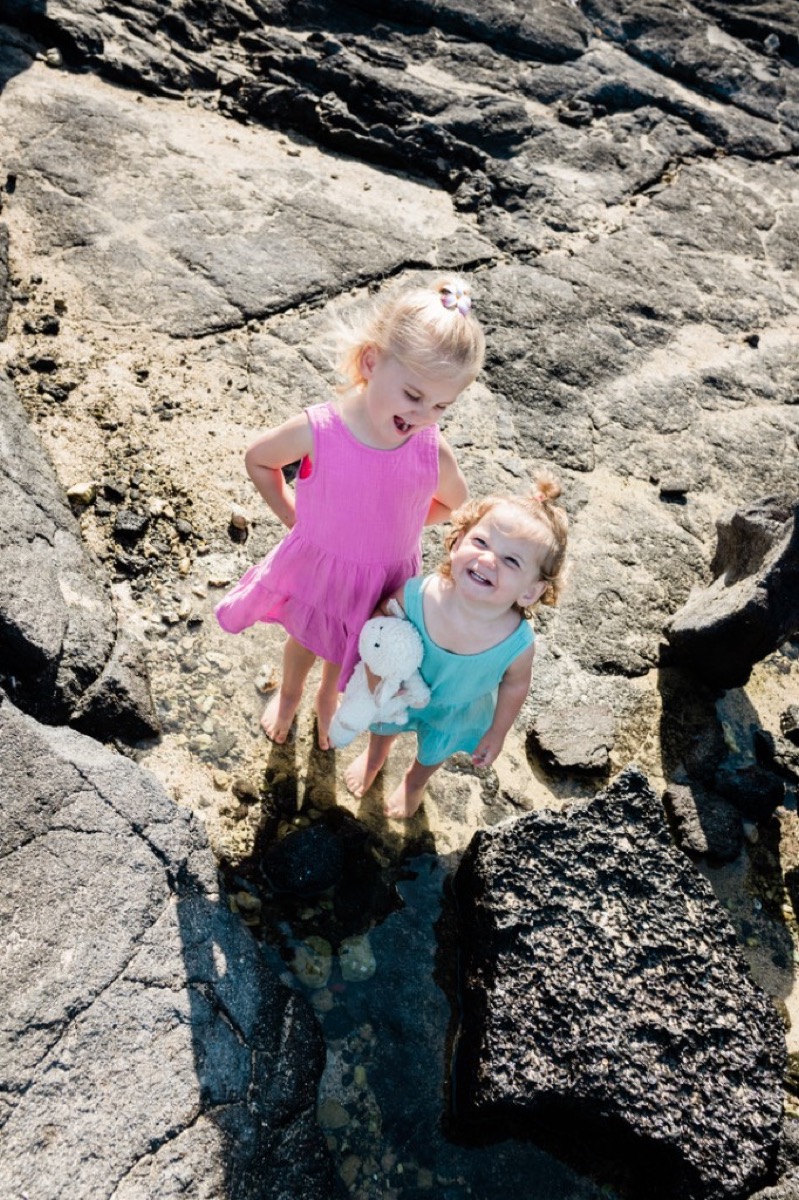 Makena and Morgan on lava rock in Hawaii
