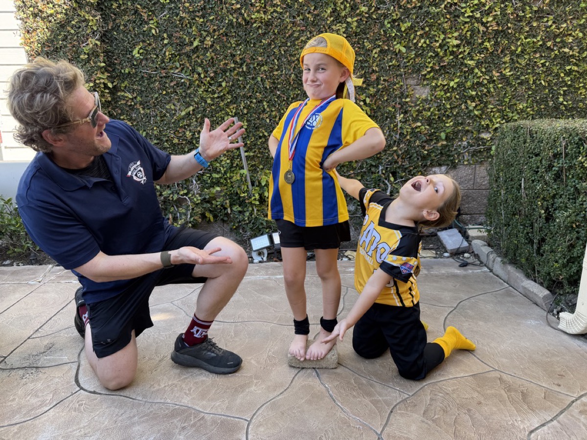 Kyle kneeling as Makena stands on a podium in soccer gear with a medal while Morgan cheers in softball uniform
